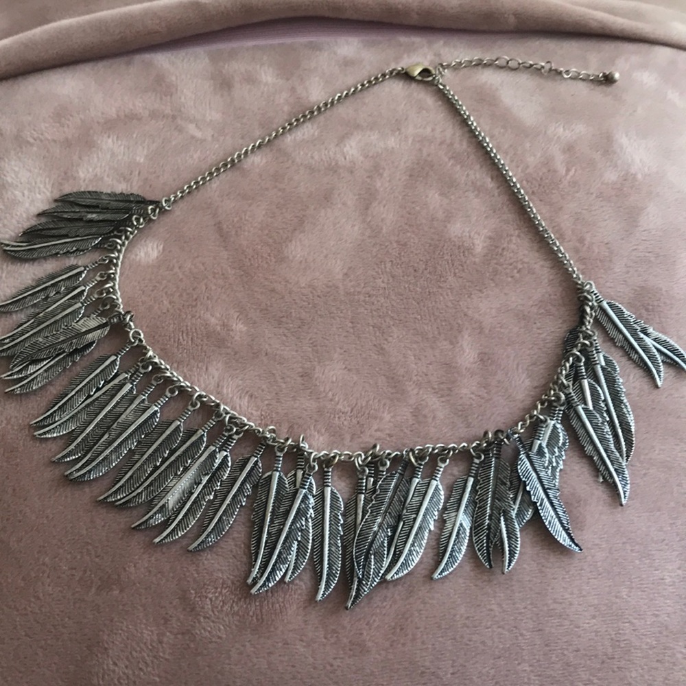 Silver necklace with feather details.